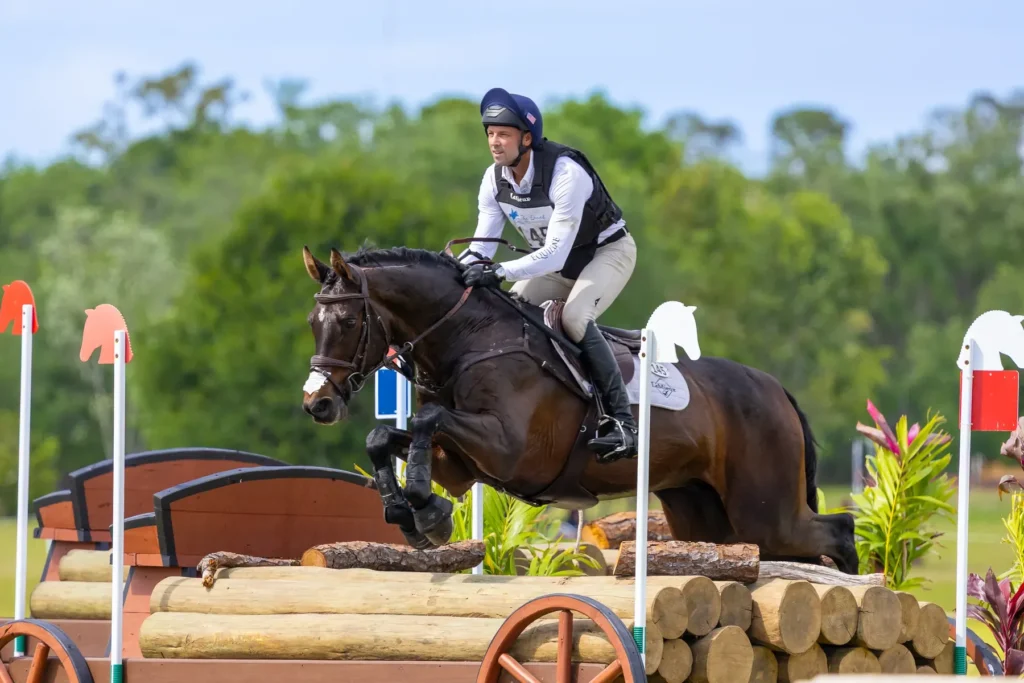 Eventing rider jumping a cross-country log fence at TerraNova Equestrian Center