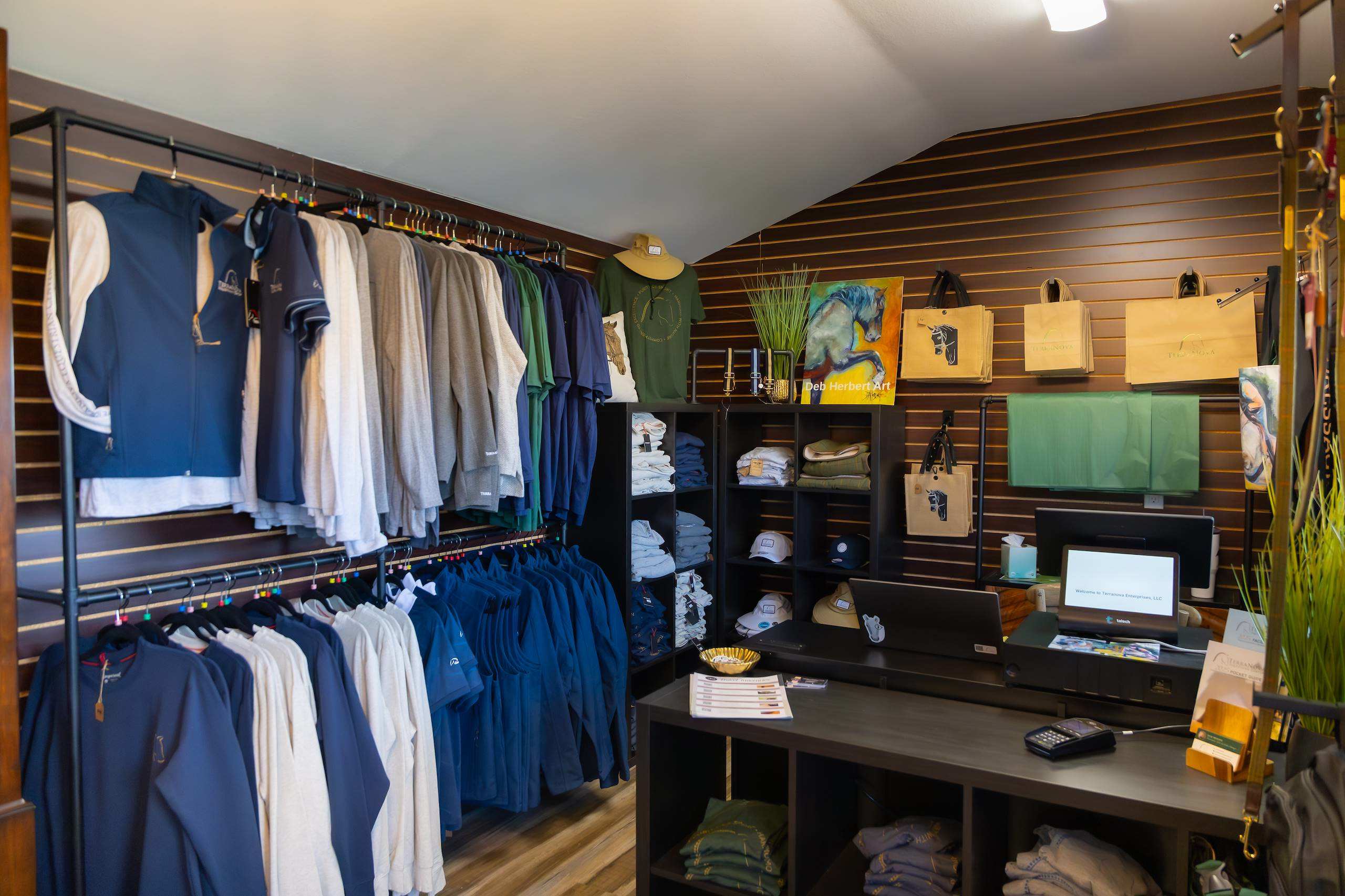 Racks of branded apparel and shelves of accessories inside a small boutique