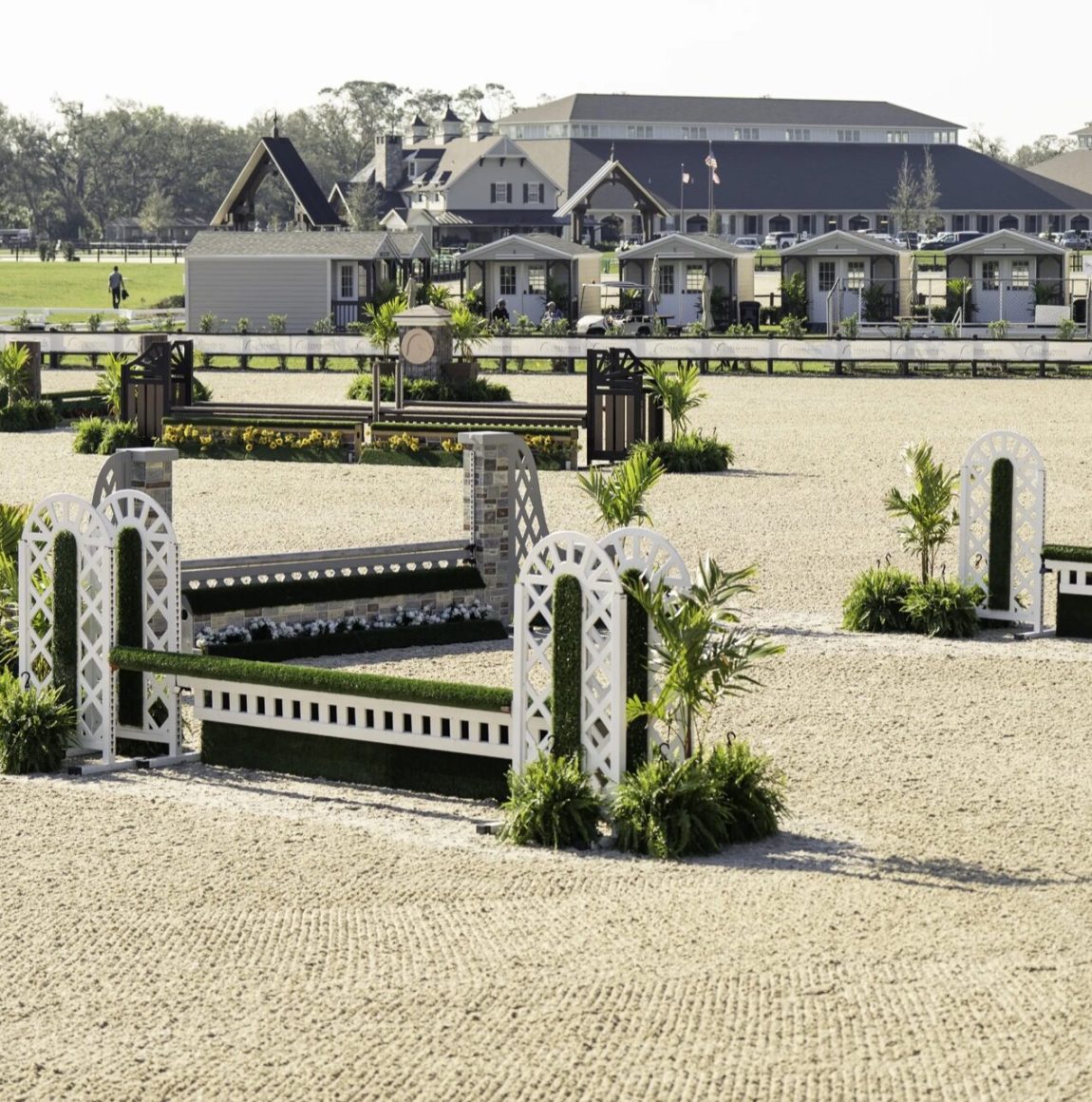 Show jumping arena with vendor cottages and stabling at TerraNova Equestrian Center